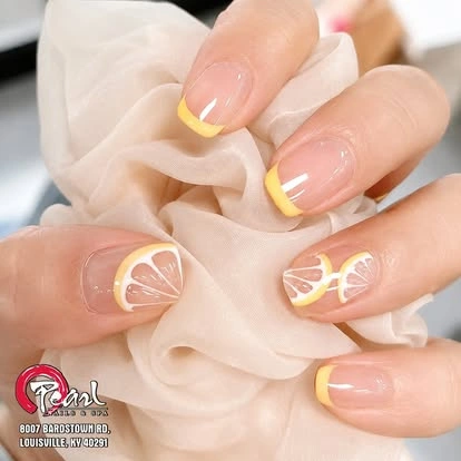 Yellow French tips with citrus nail art at Pearl Nails ’n Spa