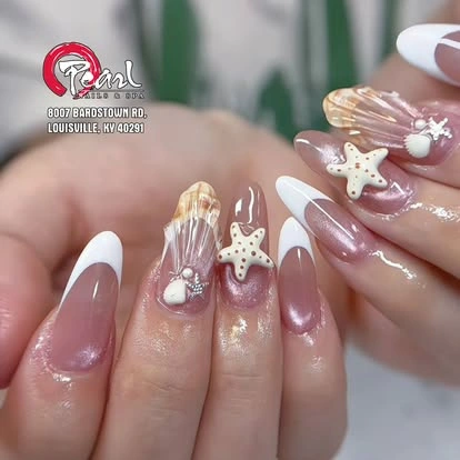 Pearl and butterfly embellished nails at Pearl Nails ’n Spa