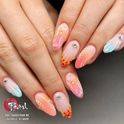 Peach manicure with floral accents at Pearl Nails ’n Spa